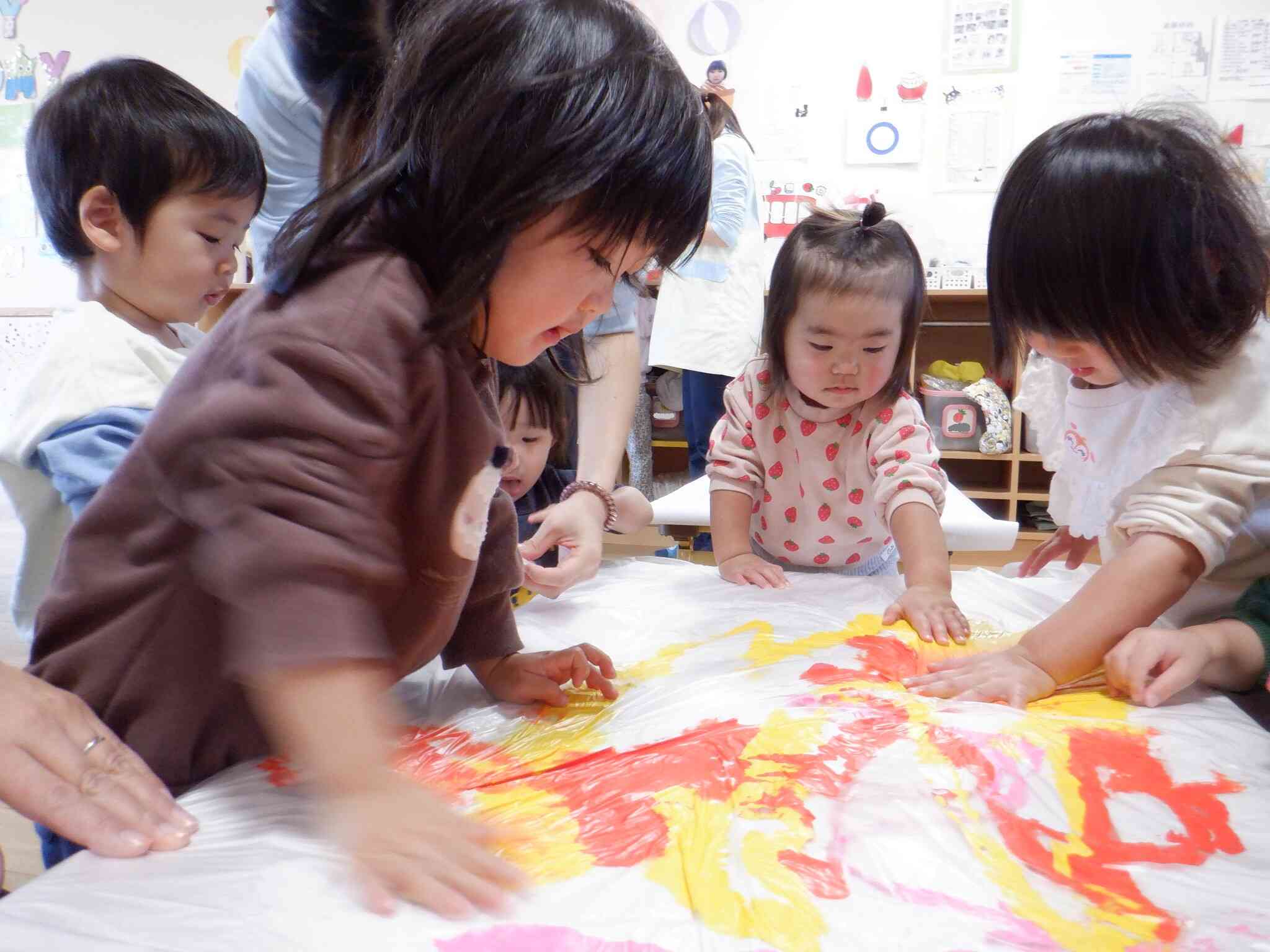 わぁ～絵の具の感触楽しい！　あひる１組（１歳児）