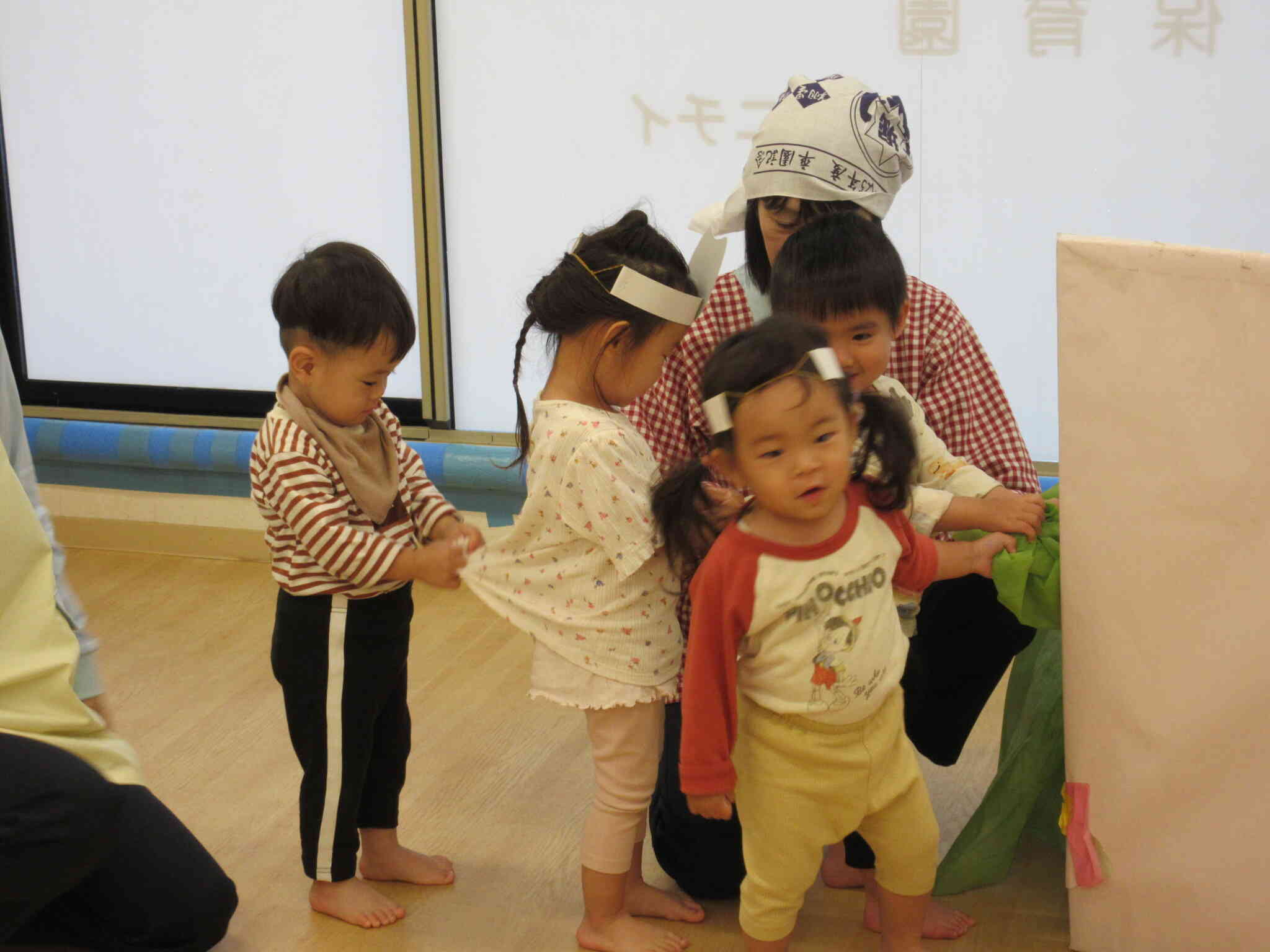 お友達の服をそっと引っ張ってかぶを抜くお手伝い！