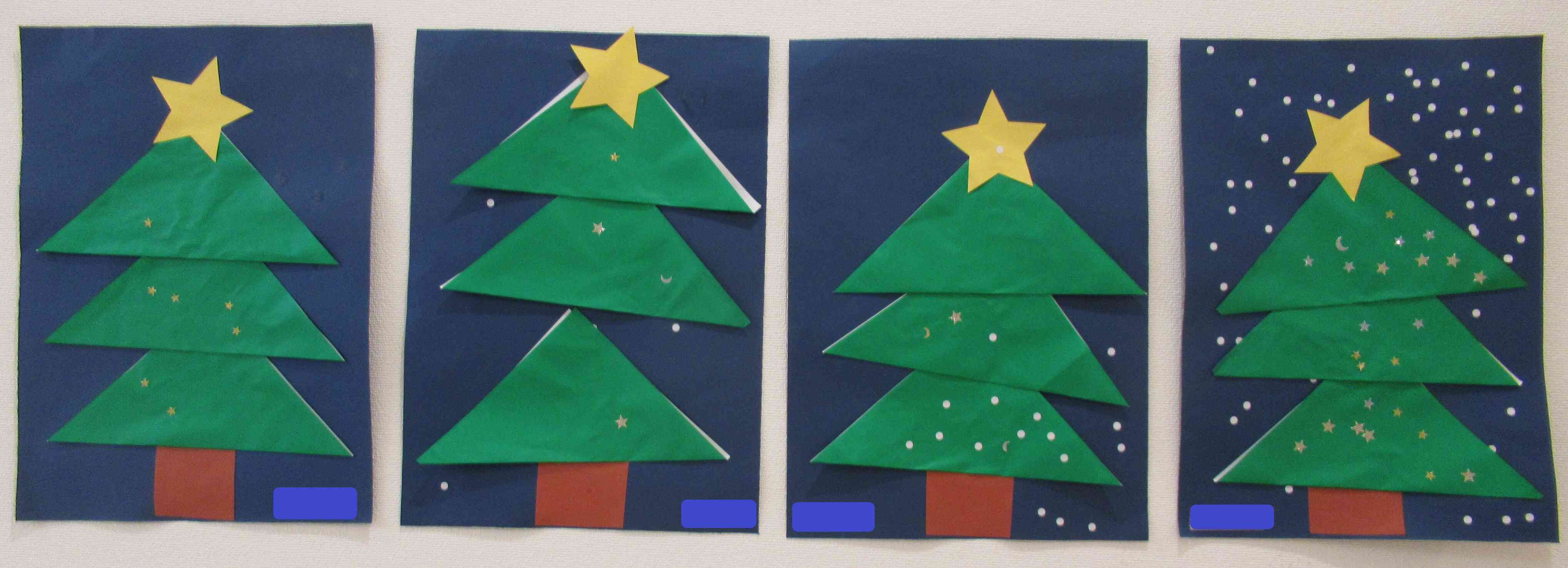 2歳児さんは折り紙を折ることに挑戦！自分で三角に折った折り紙にシールで飾り付け♪手先が器用になり小さなシールも貼れるようになりました☆