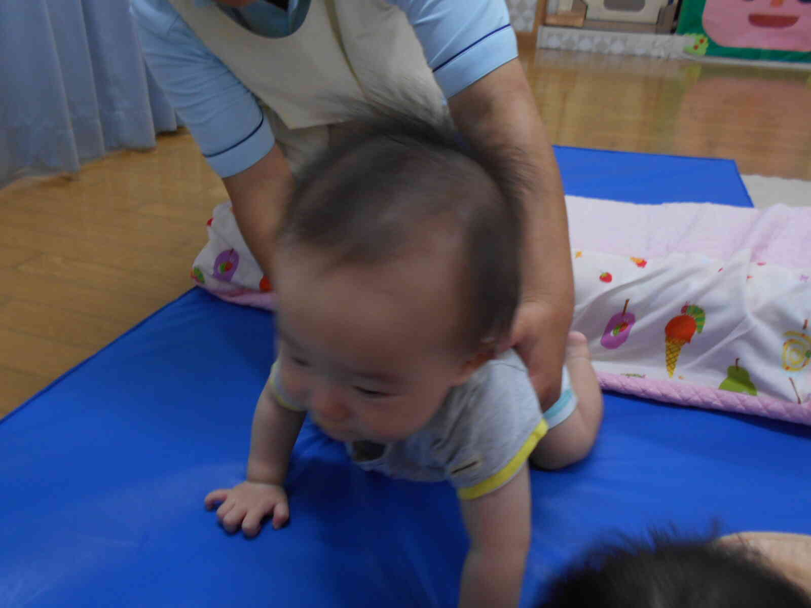 保育者に支えてもらいながら慎重に渡っています。